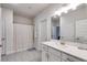 Bright bathroom with a large vanity, granite countertops, and a shower with white accents at 197 Saddleridge Dr, Bremen, GA 30110