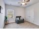 This cozy bedroom features a neutral color palette, a comfortable chair, and natural light from the window at 197 Saddleridge Dr, Bremen, GA 30110
