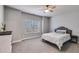 Cozy bedroom featuring a ceiling fan, gray walls, neutral carpet, and natural light from the window at 197 Saddleridge Dr, Bremen, GA 30110