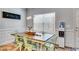 Bright dining room featuring a wooden table, stylish decor, and a large window with modern light fixtures at 197 Saddleridge Dr, Bremen, GA 30110