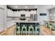 Bright kitchen featuring white cabinets, granite countertops, and a large island with seating for casual dining at 197 Saddleridge Dr, Bremen, GA 30110