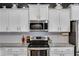 Kitchen with granite countertops, stainless steel appliances, white cabinets, and tile backsplash at 197 Saddleridge Dr, Bremen, GA 30110