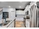 Bright kitchen featuring granite countertops, stainless steel appliances, and white cabinetry at 197 Saddleridge Dr, Bremen, GA 30110