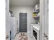 Functional laundry room with washer, dryer, storage shelves, and plenty of space at 197 Saddleridge Dr, Bremen, GA 30110
