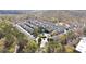 Aerial view shows community layout with landscaping, roads, and proximity to wooded areas at 3540 Chattahoochee Summit Se Ln # 28, Atlanta, GA 30339