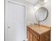 Bathroom features vanity with bowl sink, round mirror, and neutral color palette at 3540 Chattahoochee Summit Se Ln # 28, Atlanta, GA 30339