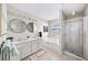 Bathroom featuring double sinks, a soaking tub, and a separate shower at 3540 Chattahoochee Summit Se Ln # 28, Atlanta, GA 30339