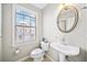 Cozy half bath with a pedestal sink and a window providing natural light at 3540 Chattahoochee Summit Se Ln # 28, Atlanta, GA 30339