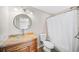 Bright bathroom featuring a glass bowl sink, wooden cabinets, and tub with a shower at 3540 Chattahoochee Summit Se Ln # 28, Atlanta, GA 30339