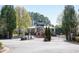 Exterior view of the gated entrance and community clubhouse with lush landscaping at 3540 Chattahoochee Summit Se Ln # 28, Atlanta, GA 30339