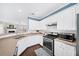 Bright kitchen with stainless appliances, hardwood floors, and a view into the adjacent living space at 3540 Chattahoochee Summit Se Ln # 28, Atlanta, GA 30339