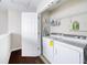 Convenient laundry room with washer, dryer, and storage shelving at 3540 Chattahoochee Summit Se Ln # 28, Atlanta, GA 30339