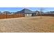 Expansive fenced backyard with mature trees and a covered patio, perfect for recreation at 60 Streamside Dr, Covington, GA 30016