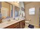 Dual sink bathroom with framed mirrors, vanity and nearby toilet at 60 Streamside Dr, Covington, GA 30016