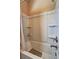 Clean and bright bathtub with shower head and built-in shelving at 60 Streamside Dr, Covington, GA 30016