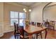 Dining room with a large wooden table, wainscoting, chandelier and hardwood floors at 60 Streamside Dr, Covington, GA 30016