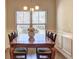 Dining room with hardwood floors, a large window, and a wooden dining table at 60 Streamside Dr, Covington, GA 30016