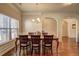 Bright dining room featuring wood floors, a chandelier, and adjacent rooms at 60 Streamside Dr, Covington, GA 30016