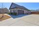 Spacious home featuring an attached two-car garage and a large concrete driveway at 60 Streamside Dr, Covington, GA 30016