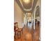 Elegant hallway featuring hardwood floors, arched doorways, and decorative moldings at 60 Streamside Dr, Covington, GA 30016