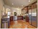 Open kitchen featuring stainless appliances, wood cabinets and granite countertops at 60 Streamside Dr, Covington, GA 30016