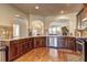 Open kitchen featuring stainless appliances, wood cabinets and granite countertops at 60 Streamside Dr, Covington, GA 30016