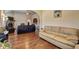 Open-concept living area with hardwood floors, fireplace and view to the kitchen at 60 Streamside Dr, Covington, GA 30016