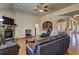 Inviting living room featuring a stone fireplace, ceiling fan, and hardwood floors at 60 Streamside Dr, Covington, GA 30016