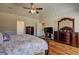 Main bedroom with hardwood floors, ceiling fan and a large dresser at 60 Streamside Dr, Covington, GA 30016