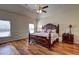 Spacious main bedroom with ceiling fan, hardwood floors, and a king-sized bed at 60 Streamside Dr, Covington, GA 30016