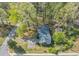 Aerial view of a charming home nestled among lush trees, offering a serene and private setting at 9258 Westview Sw Dr, Covington, GA 30014