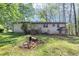 View of the home's backyard featuring a brick exterior, stairs, and a small covered area at 9258 Westview Sw Dr, Covington, GA 30014