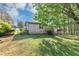 Side view of home with a brick exterior and well-maintained lawn and mature trees in the backyard at 9258 Westview Sw Dr, Covington, GA 30014