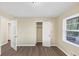This bedroom features neutral walls, updated floors, and a bright window with a view of the outdoors at 9258 Westview Sw Dr, Covington, GA 30014