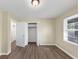 This bedroom features neutral walls, updated floors, and a bright window with a view of the outdoors at 9258 Westview Sw Dr, Covington, GA 30014