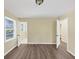 This bedroom features neutral walls, updated floors, and a bright window with a view of the outdoors at 9258 Westview Sw Dr, Covington, GA 30014
