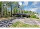 Single-story brick home surrounded by mature trees, with a driveway at 9258 Westview Sw Dr, Covington, GA 30014