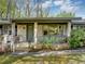 Charming brick porch with wrought iron railings and a gray front door at 9258 Westview Sw Dr, Covington, GA 30014