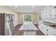 Open kitchen design with stainless steel refrigerator and gray marbled island, flowing to an outdoor view at 9258 Westview Sw Dr, Covington, GA 30014