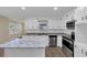 Bright kitchen with white cabinets, granite countertops, and modern appliances at 9258 Westview Sw Dr, Covington, GA 30014