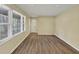Bright living room featuring wood-look flooring and ample natural light from large windows at 9258 Westview Sw Dr, Covington, GA 30014