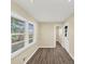 Bright room featuring wood-look flooring, large windows with blinds, and neutral wall colors at 9258 Westview Sw Dr, Covington, GA 30014