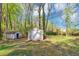 Backyard with two storage sheds, surrounded by mature trees offering ample storage space at 9258 Westview Sw Dr, Covington, GA 30014