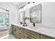 Bright bathroom featuring double vanity with modern fixtures and mirrors, with a view into an adjacent bedroom at 1171 State St # B, Atlanta, GA 30318