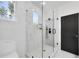 Modern bathroom showcases a glass-enclosed shower with marble tile, sleek fixtures, and a contrasting black door at 1171 State St # B, Atlanta, GA 30318