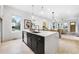 Open-concept kitchen featuring a large island with a sink and a view of the dining and living areas at 1171 State St # B, Atlanta, GA 30318