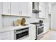 Close-up of the modern kitchen with stainless steel appliances, white cabinets, and quartz countertops at 1171 State St # B, Atlanta, GA 30318
