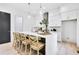 Modern kitchen featuring a large island with seating, stainless steel appliances, and sleek white cabinetry at 1171 State St # B, Atlanta, GA 30318