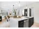 Kitchen island features a stainless steel dishwasher, quartz countertops, and a view to the living area at 1171 State St # B, Atlanta, GA 30318