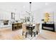 A modern kitchen and dining area with an island, stainless appliances, and pendant lighting at 1171 State St # B, Atlanta, GA 30318